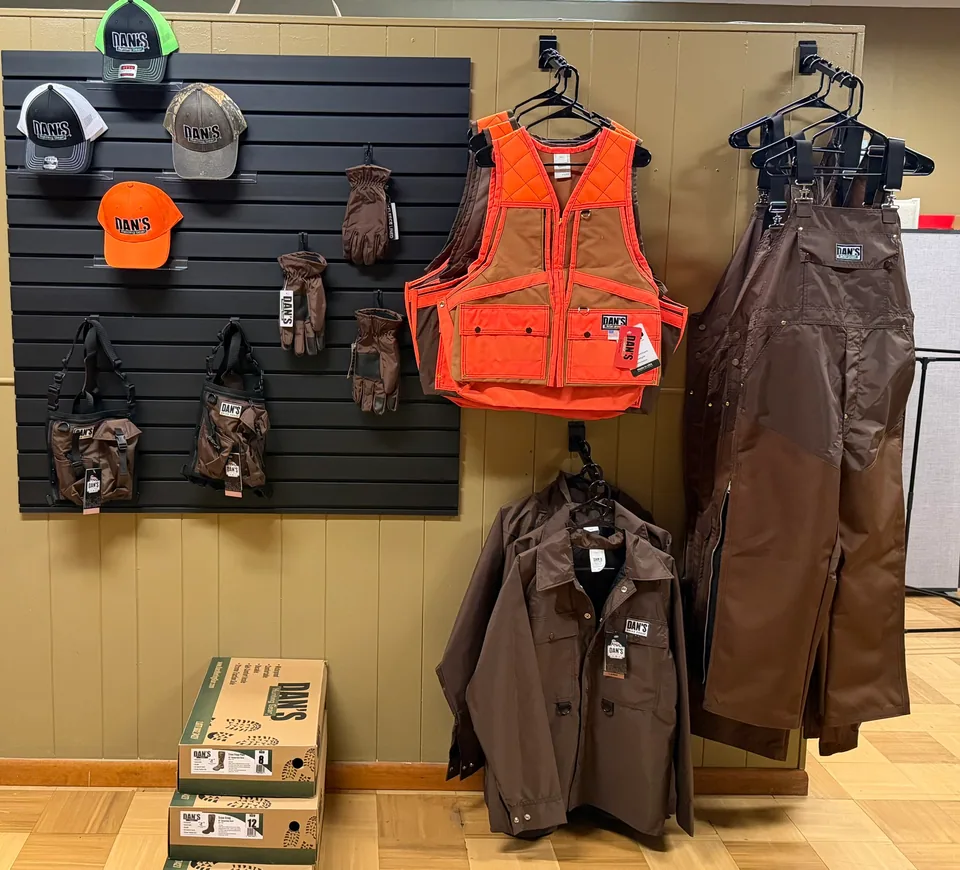 Dan's Hunting Gear briar-proof vests, bibs, jackets, caps, and gloves on display