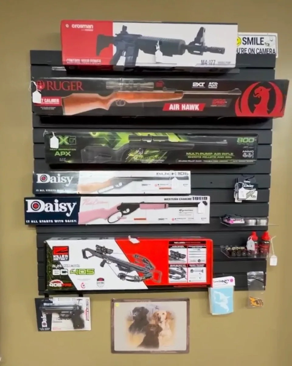 Wall of air rifles and a crossbow — Crosman, Ruger, Daisy, and Umarex models on display